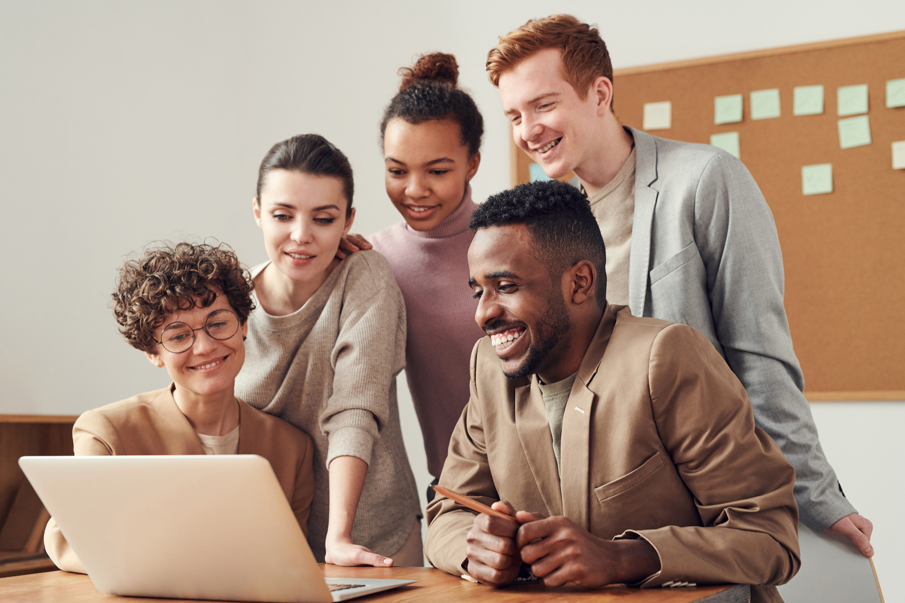 Diverse Colleagues Looking at a Laptop Indoors